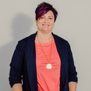 Portrait of woman with short purple hair.